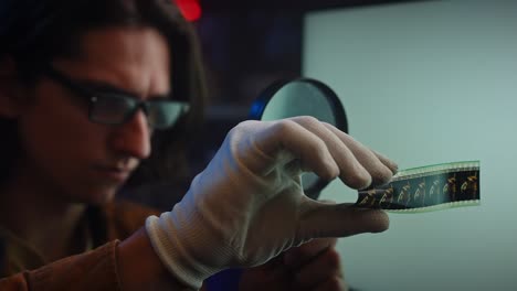 Film Archivist Examining a Filmstrip