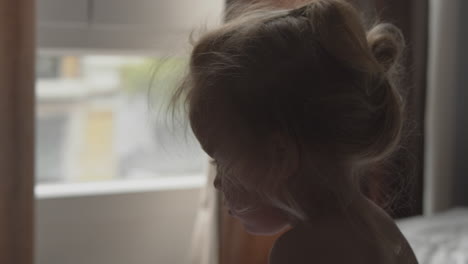 little girl with tousled hair in the morning