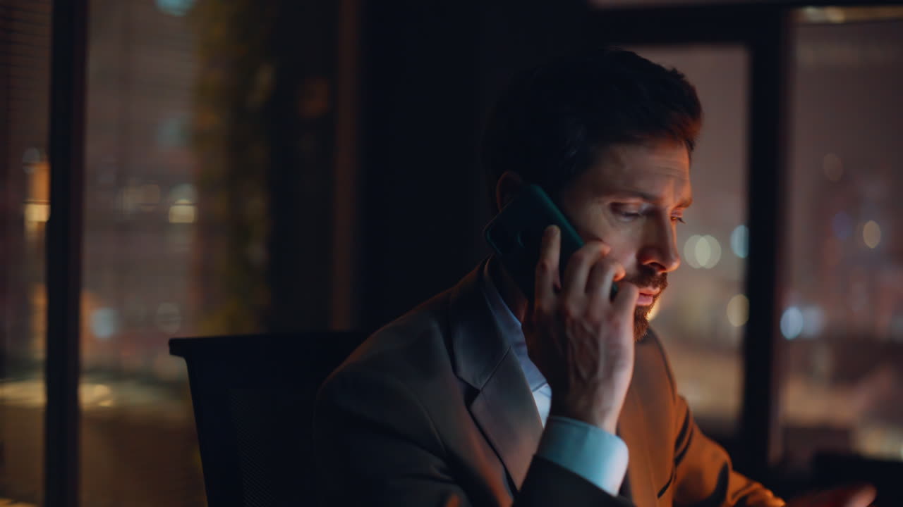 Exhausted professional calling night office portrait. Stressed businessman chat
