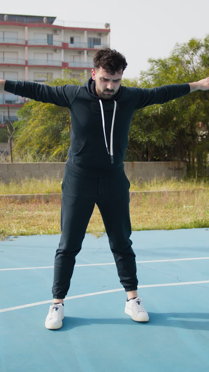 Man Stretching on Basketball Court