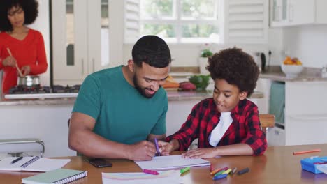 Father-helping-son-to-paint-at-home