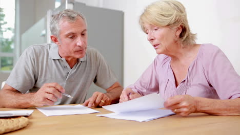 Couple-signing-documents-together