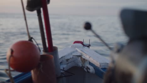 shot of fishing boat out at sea with equipment and buoys