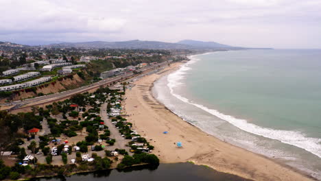 aerial view of coastal landscape with beach, river, and ocean