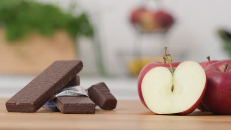 Organic-apples-and-sweet-chocolate-wafer-on-kitchen-worktop