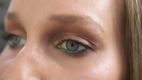 Close-up-shot-of-a-woman-opening-her-green-eyes-with-light-day-make-up-and-focusing-them.-Attractive-beautiful-young-woman-opens