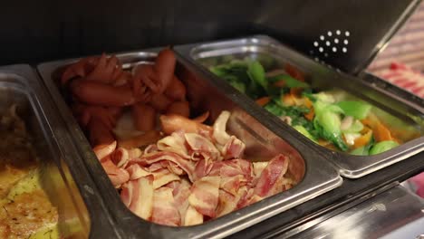 sequential filling of buffet trays with food