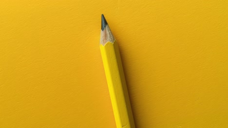 sharp yellow pencil on vibrant yellow background