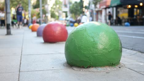 colorful bollards on a city street