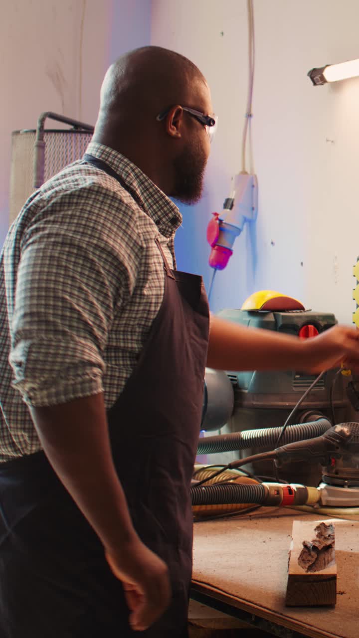 African American Woodworker Carving Wood in a Workshop
