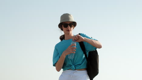 Woman-with-water-bottle-and-backpack