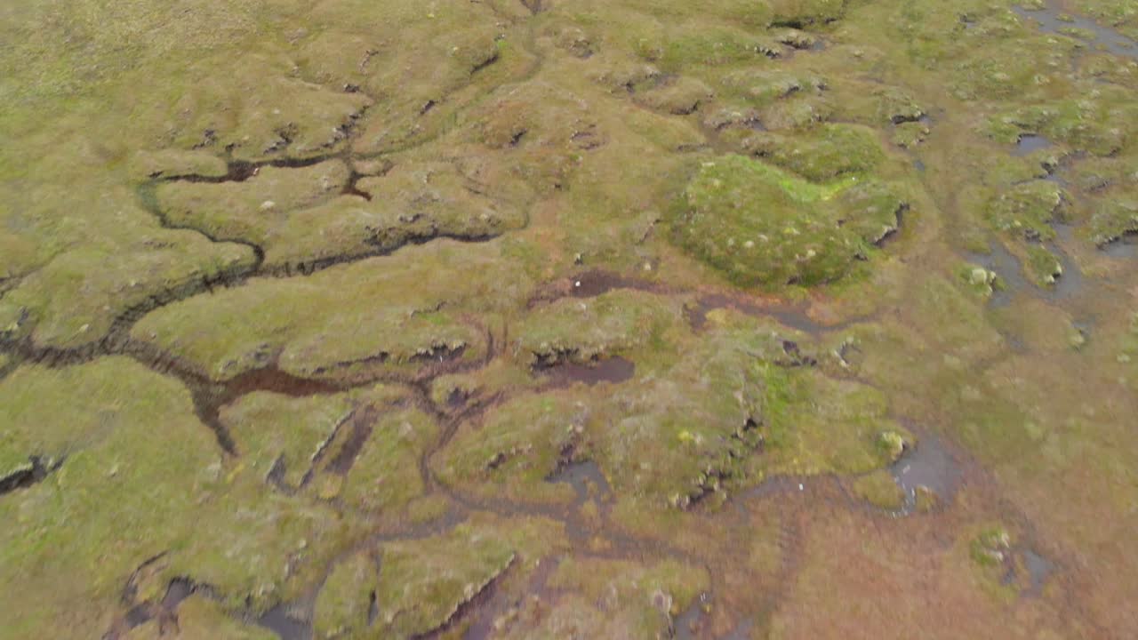 Top down aerial shot of wet grass lands in Scotland.