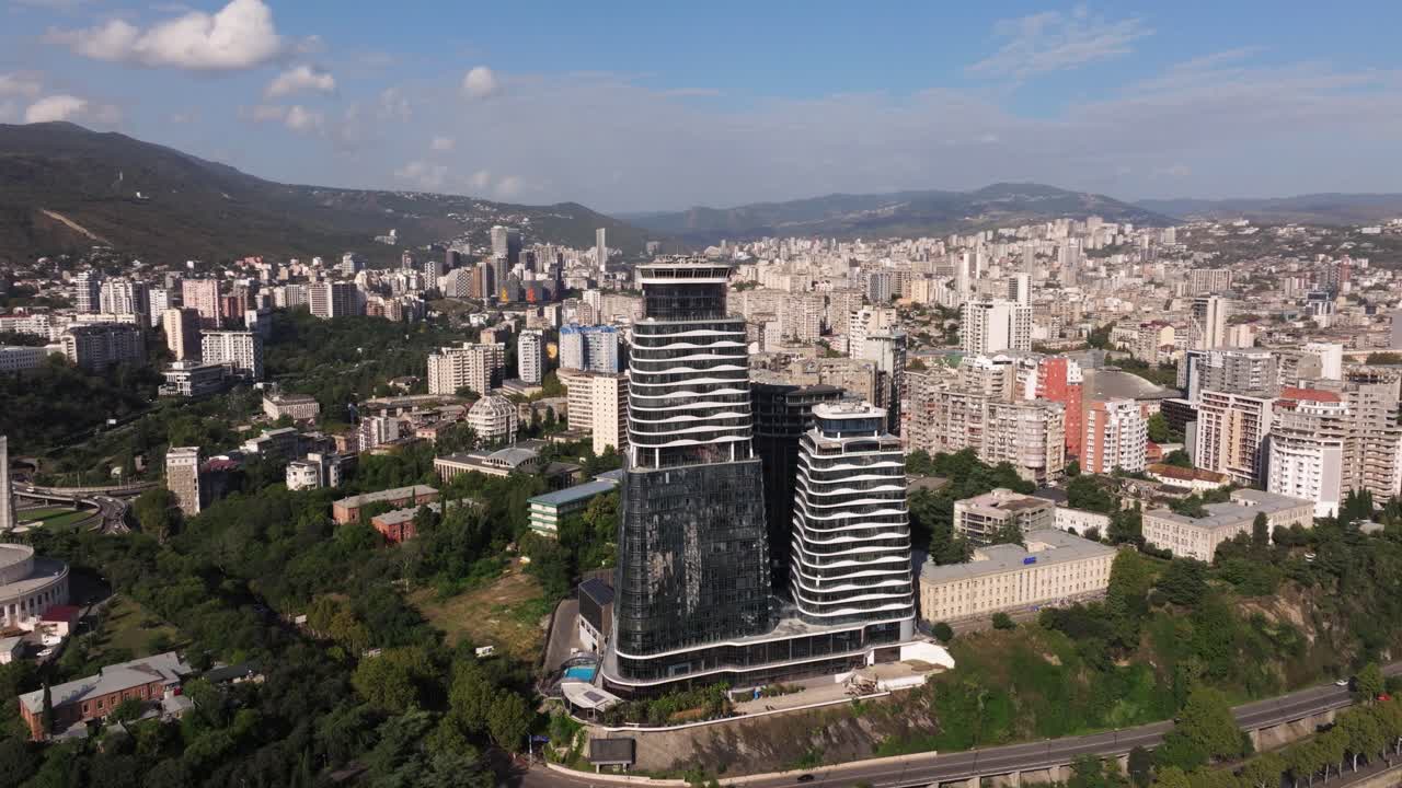 Orbiting Drone Shot Above The Biltmore Hotel Tbilisi, Georgia. Modern Skyscraper