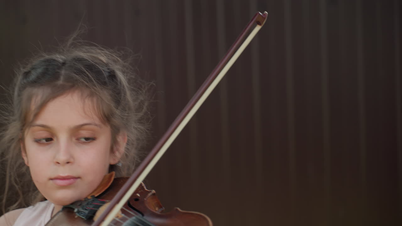 Contemplative Young Woman Playing Fiddle, Reflective Young Performer Showcasing Deep Musical Thoughtfulness, Pensive Caucasian Girl Engaged In Rehearsing Her Musical Piece Intimately