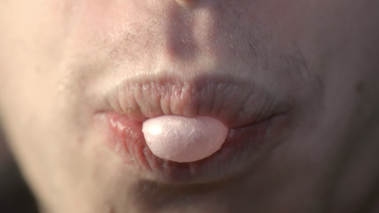 Guy Chewing And Popping Bubblegum - Extreme Closeup Shot