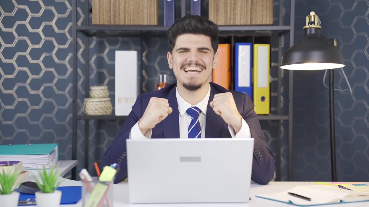 joven empresario exitoso regocijándose con buenas noticias.