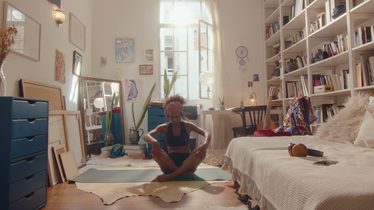 Black Girl Beginning Yoga Practice in Sunlit Room