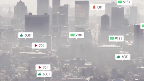 Animation-of-multiple-social-media-icons-floating-against-aerial-view-of-cityscape