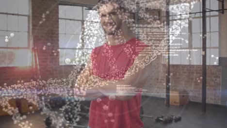 Medical-data-processing-against-portrait-of-caucasian-fit-man-smiling-while-standing-at-the-gym