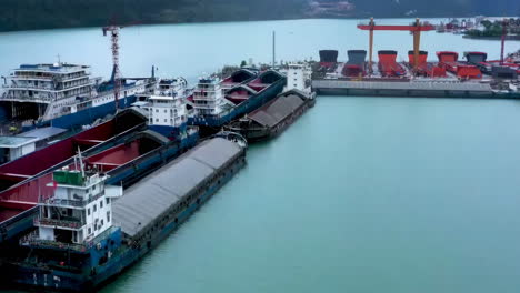 aerial view of barges and ships at a river port