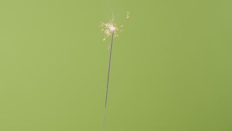 lighting a sparkler in front of a chroma greenscreen