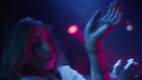 woman dancing in neon lights at nightclub