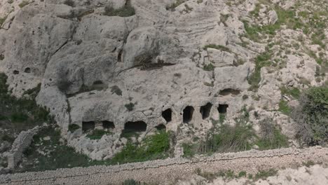 aerial view of an ancient byzantine cave church ruins in sicily south italy panning down slowly