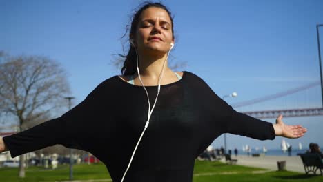 Calm-sporty-girl-with-closed-eyes-training-outdoor