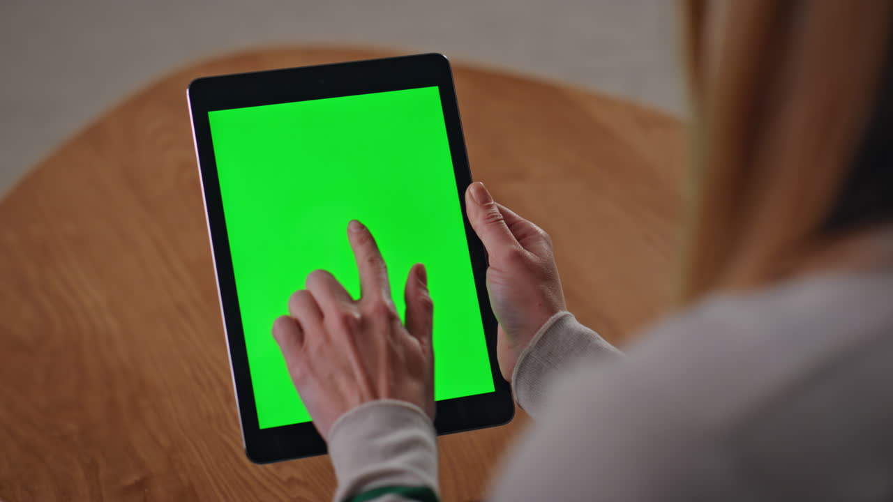 Freelancer working mockup tablet at desk close up. Woman touching green screen