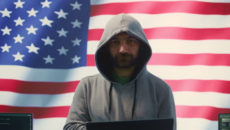 A hacker working in a governmental IT workspace with the USA flag