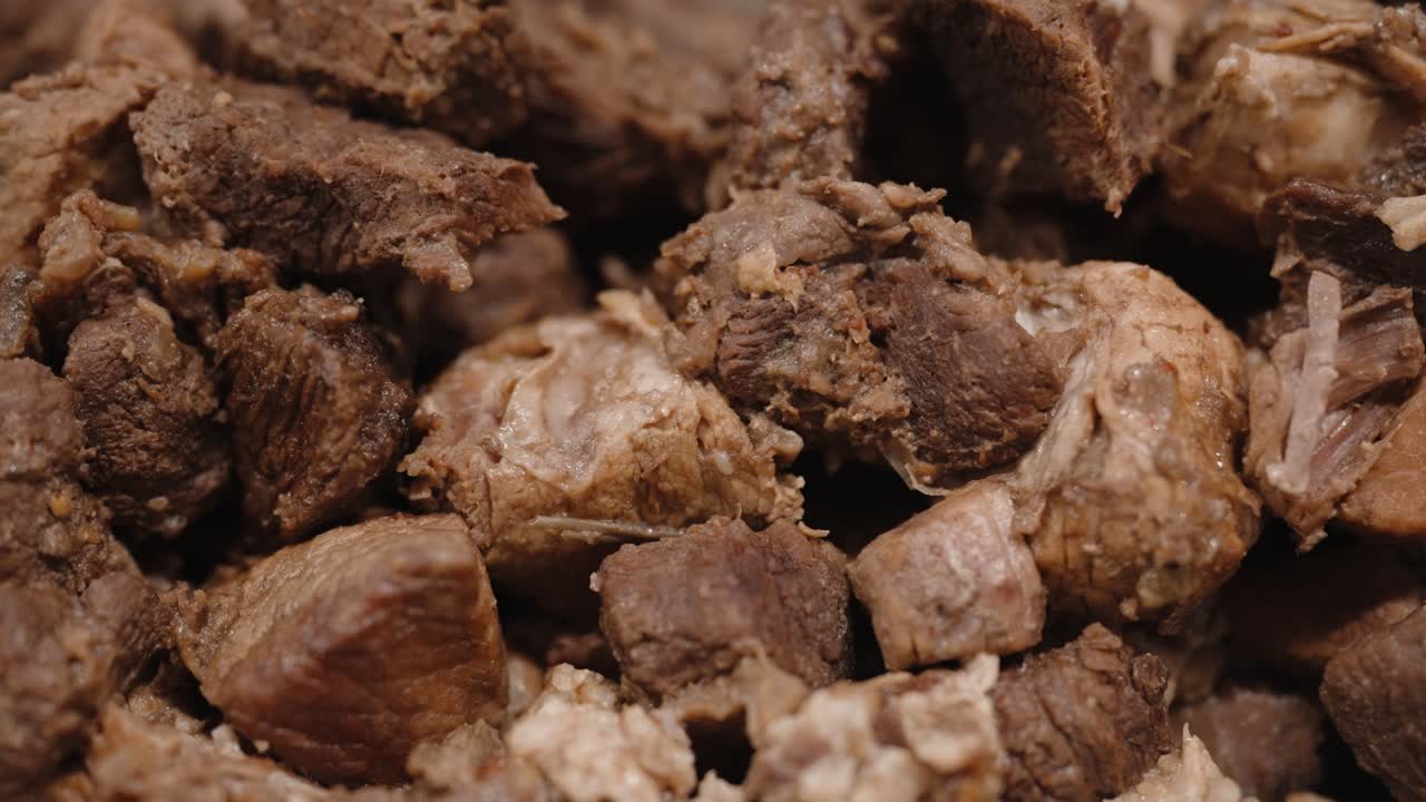 Macro view of cooked meat chunks with visible texture