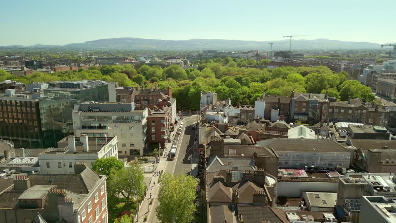 Reversing aerial of Dublin City Centre and St Stephen's Green in Dublin, County Leinster, Ireland. The Luas passes underneath. Filmed in 4K, 60FPS and with Rec709 color.