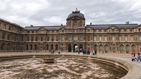 visitors walking around a grand european palace courtyard