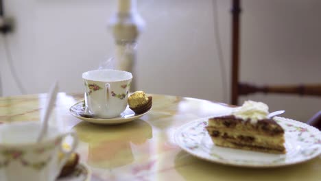 medium close up of coffe steaming with fresh cake served in vintage rustic restaurant slow motion