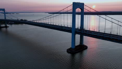 an aerial time lapse of the throgs neck bridge during a beautiful sunrise, seen from queens, new york