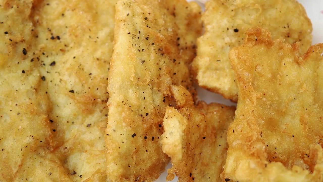 Close-up of Crispy Fried Fish Fillets on a Plate