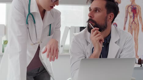 Handheld-view-of-doctors-discussing-some-medical-records