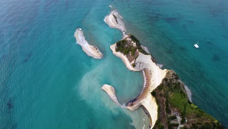 cape of drastis complex of rocks with an anchored catamaran, corfu, greece