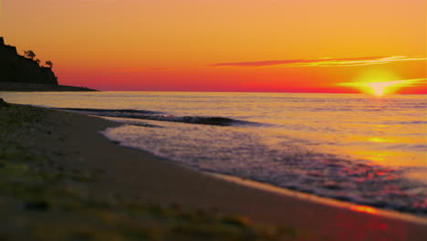 panoramic landscape rock silhouette at orange sunrise morning. ocean wave