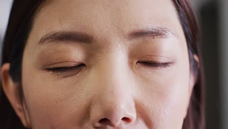 video close up portrait of the opening eyes of asian female doctor