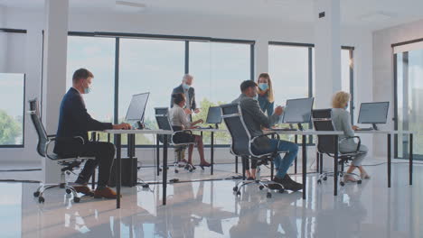 employees working in a modern office during pandemic