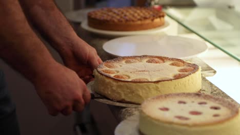 freshly baked cake placed on porcelain plate prepared for display on bakeshop. - high angle shot