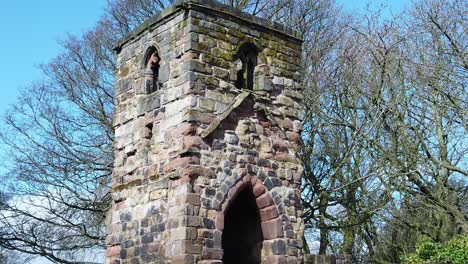 Historic-Windleshaw-Chantry-stonework-tower-exterior-slow-motion-towards-ruins-against-blue-sky