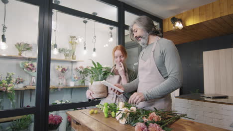 florists chatting during work in flower shop
