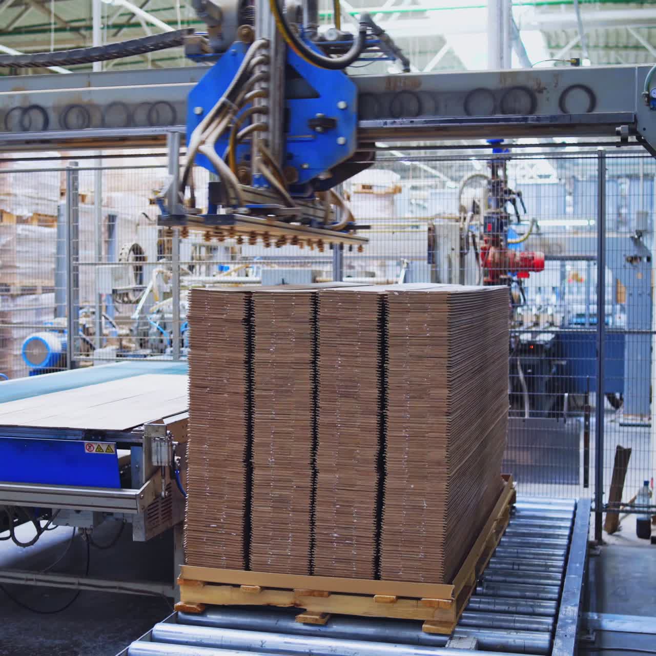 Automated equipment for laminate production. Modern robotic factory indoors. Woodworking production.