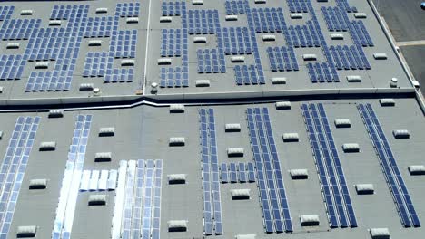 photovoltaic solar panels on commercial building roof, renewable energy concept, aerial topdown sideways