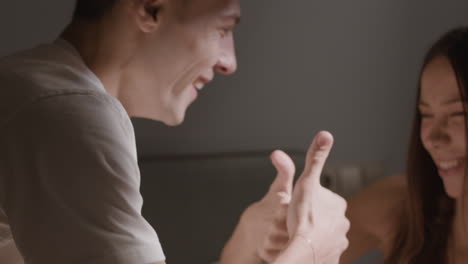happy couple using devices at night