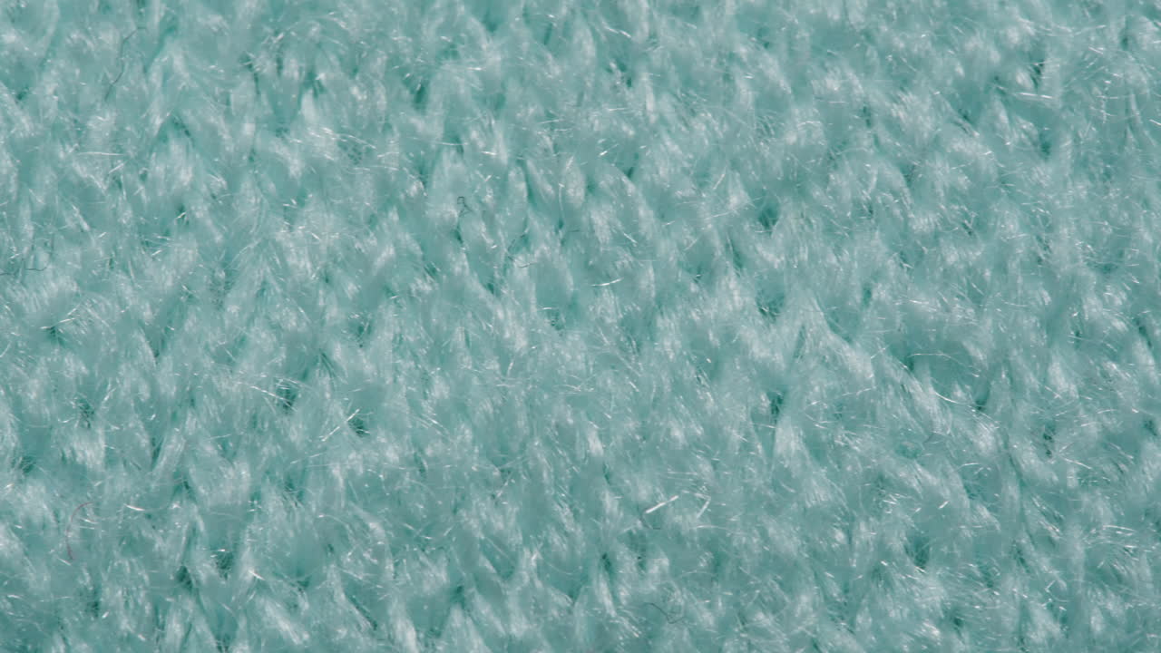 Close-up view of a teal knitted fabric