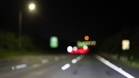 blurred lights of vehicles on a night road