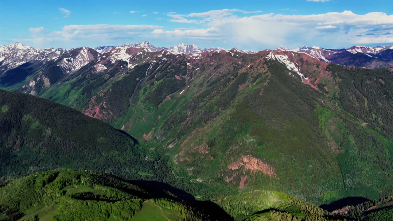 Aspen Mountain Ajax Little Annie Trailhead aerial drone Colorado Conundrum creek trail Castle Peak 14er Rocky Mountains Elk Range Aspen Trees spring summer morning blue sky clouds pan left motion